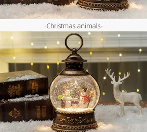 Vintage copper Christmas lantern featuring a snowman family scene with warm glowing lights