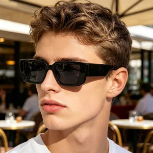 Close-up of stylish men's rectangular sunglasses with black frames and dark gray lenses