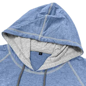 Close-up of hooded short sleeve top with gray lining, drawstrings, and white contrast stitching