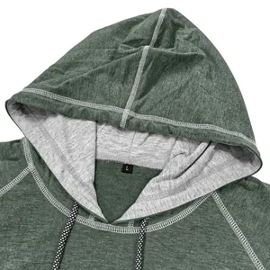 Detail of hooded t-shirt with contrast stitching, grey lining, and braided drawstring