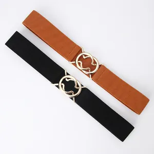 Detail of interlocking gold circular buckles on black and brown elastic waist belts