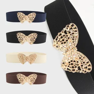 Detail of elegant butterfly metal buckle on elastic waist belt for stylish women