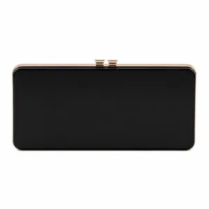 Detail view of a black rectangular clutch bag with a metallic gold clip and glossy finish