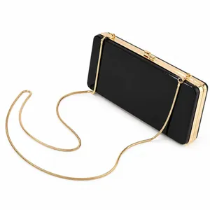 Elegant black acrylic rectangular clutch bag with gold metal frame and snake chain strap