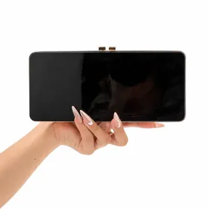 Elegant black patent leather clutch with a gold-tone metallic clasp for evening wear