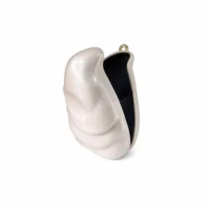 Detailed view of pearlescent acrylic evening bag with gold clasp and black lining