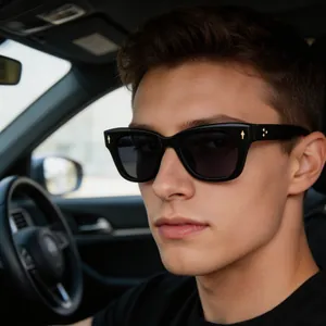 Close-up of polarized sports sunglasses on male driver featuring gold metal arrow rivets