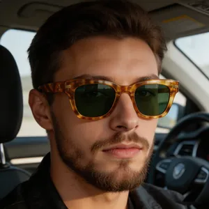 Detail of tortoise shell sunglasses with dark green lenses and metal hinge cross accent