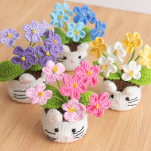Detail showing colorful hand-knitted lily of the valley flowers in cute animal shaped pots