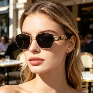 Detail of gold steampunk sunglasses with Greek key pattern and dark lenses on a model