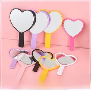 Close-up of colorful heart-shaped handheld makeup mirrors in various pastel shades