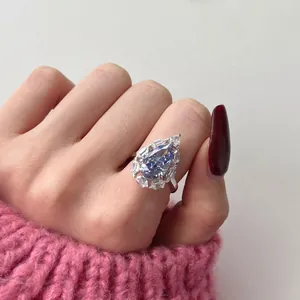 Elegant S925 sterling silver ring with pear-cut blue zircon stone worn by a female model