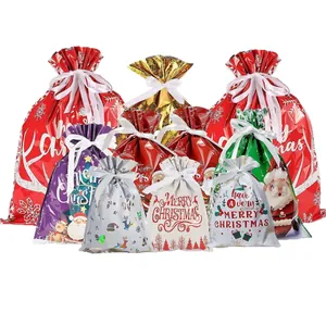 Assorted Christmas drawstring gift bags with festive patterns in multiple sizes and metallic colors