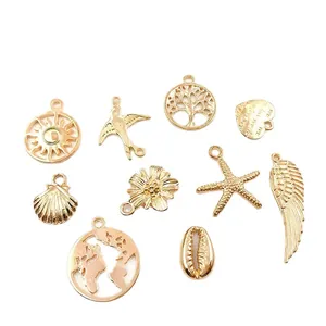 Assorted gold-tone alloy charms set featuring sun, tree, and heart shapes for DIY jewelry