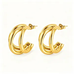Detailed view of polished triple-layer gold C-shaped hoop earrings with butterfly backs