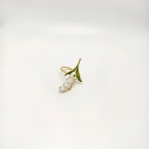 Close-up of alloy bluebell napkin ring featuring white flower buds and green leaves