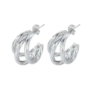 Macro detail of silver C-shaped multi-layer twisted hoop earrings with S925 hallmark