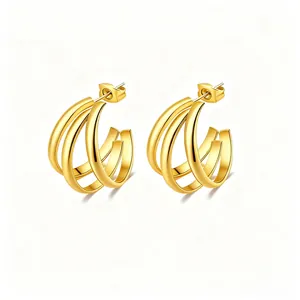 Detailed view of triple-layered gold C-shape hoop earrings with high-polish metallic finish