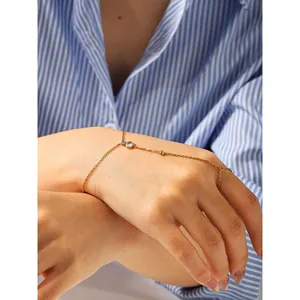 Elegant gold slave bracelet with three clear cubic zirconia stones on model