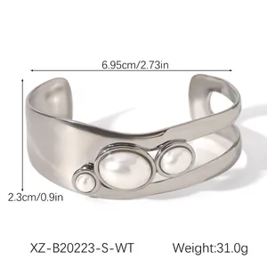 Silver-colored vintage open bangle with white faux pearls and dimensional measurements
