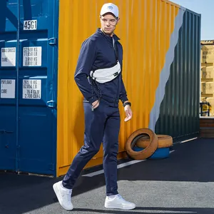 Navy blue men's tracksuit detail with stand-up collar jacket and joggers in street style