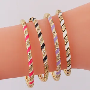 Set of four gold-plated twisted bangles with colorful enamel and sparkling rhinestones