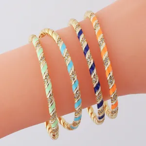 Set of four gold-plated rainbow enamel spiral bracelets with sparkling white rhinestones