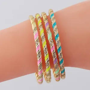Detail of four-piece gold plated spiral bracelets with colorful enamel and sparkling crystals