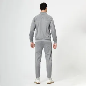 Back view of men's heather grey tracksuit featuring a stand-up collar and ribbed cuffs
