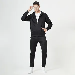 Detail of men's black tracksuit featuring ribbed cuffs and side pockets on zip jacket