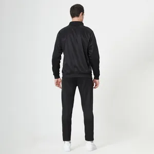 Rear view of men's black sports tracksuit featuring elastic ribbed cuffs and hem detail
