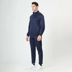 Detail of navy blue men's tracksuit featuring a stand collar jacket and tapered athletic pants