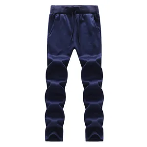 Detail of dark blue joggers featuring an elastic drawstring waist and ribbed cuffs