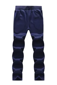 Detail view of elastic waistband on dark blue casual trousers with smooth elastic fabric