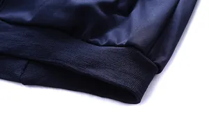Detailed view of navy blue sportswear jacket with elastic ribbed cuff and premium knit fabric