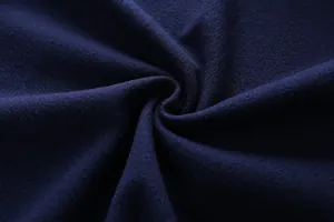 Detail shot of navy blue wool blend fabric showing thick texture and soft drape