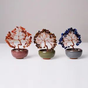 Macro view of handmade crystal money trees with red agate and tiger eye stones