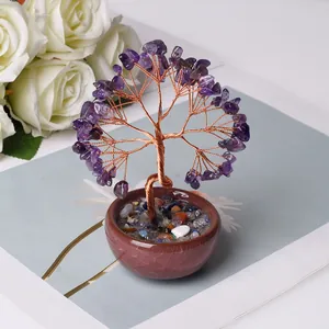 Detailed view of handmade amethyst crystal money tree with copper wire in ceramic bowl
