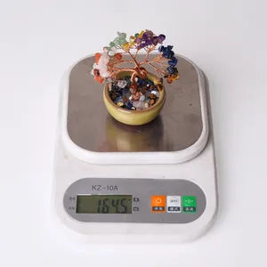 Top view of handmade crystal money tree in ceramic bowl on a scale weighing 164.5 grams