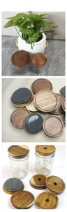 Detail of acacia wood mason jar lids with silicone rings and straw hole design