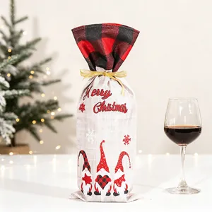 Close-up of Merry Christmas wine bottle cover with gnome patterns and gold ribbon tie