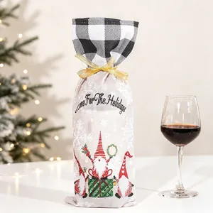 Detail of burlap Christmas wine bottle bag featuring a gnome and festive embroidery