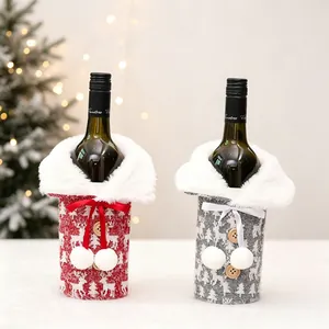 Close-up of knitted Christmas wine bottle covers with reindeer patterns and faux fur collars