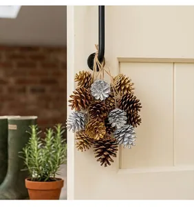 Cluster of natural pinecones in gold, silver, and wood tones hanging on a rustic rope