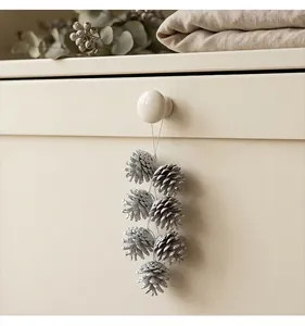 Close-up of silver glitter pine cone hanging ornaments for Christmas tree decor