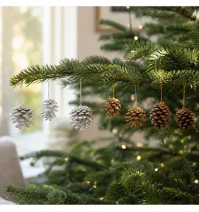 Detail of pine cone ornaments in gold, silver, and natural brown on Christmas tree