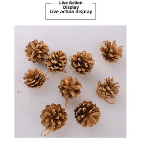 Detail of nine vintage gold pine cone ornaments with golden hanging strings for Christmas decor