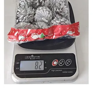 Detailed weight measurement showing approximately 82g of silver pine cone ornaments