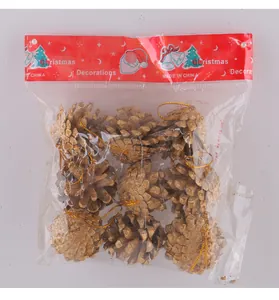 Detailed view of nine gold pine cone ornaments in Christmas decoration packaging