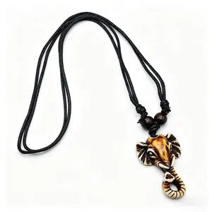 Close-up of resin elephant head pendant with antique textures and brown wooden beads
